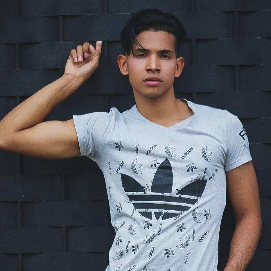 Joel Orasma Martinez — full-length portrait in Adidas tee